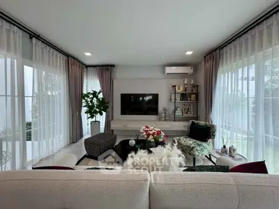 Luxurious living room with modern decor and large windows offering abundant natural light.