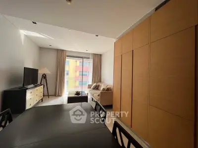 Modern living room with large window and stylish furniture in a contemporary apartment.