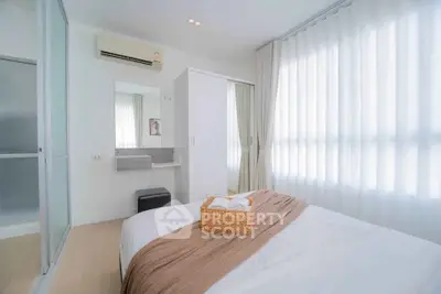 Bright and cozy bedroom with modern decor and ample natural light