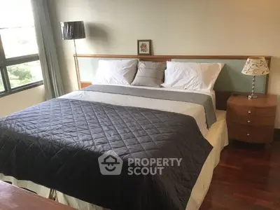 Spacious bedroom with large bed and elegant decor, perfect for relaxation and comfort.