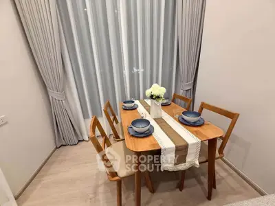 Elegant dining area with wooden table set for four, featuring modern decor and soft lighting.