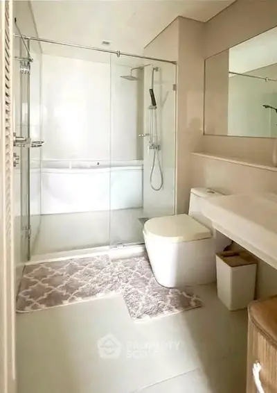 Modern bathroom with glass shower and sleek fixtures, perfect for a contemporary home.
