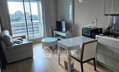 Modern living room with open kitchen and balcony view in urban apartment