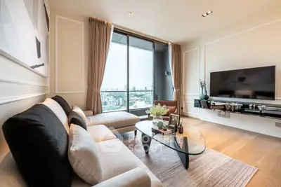 Luxurious living room with modern decor and stunning city view from large windows.