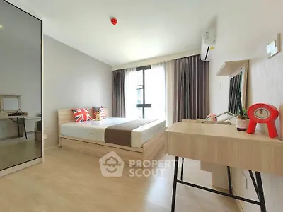 Modern bedroom with stylish decor and ample natural light in a contemporary apartment.