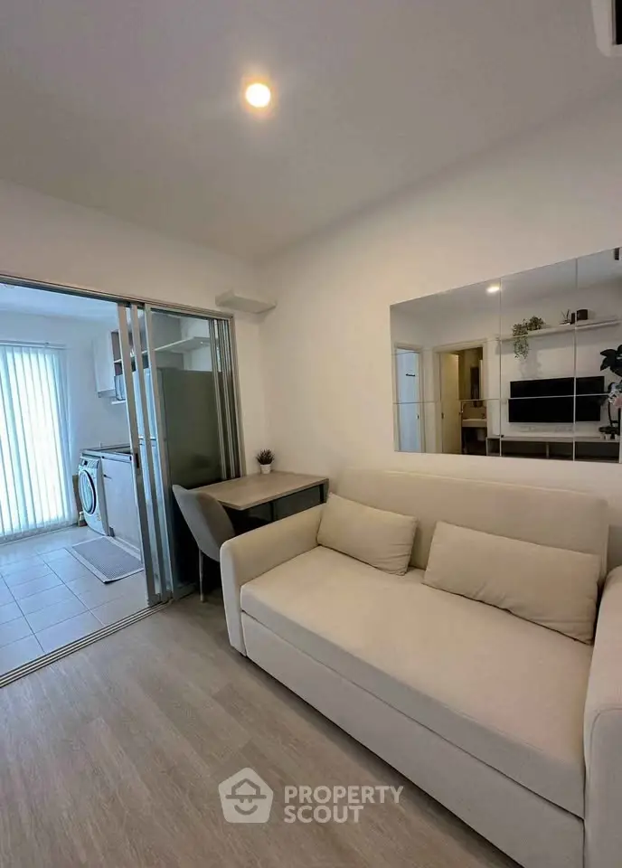 Modern living room with sliding doors and washing machine in open layout