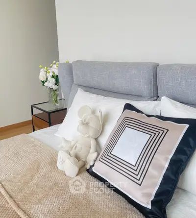 Stylish bedroom with plush bedding and modern decor, perfect for relaxation and comfort.