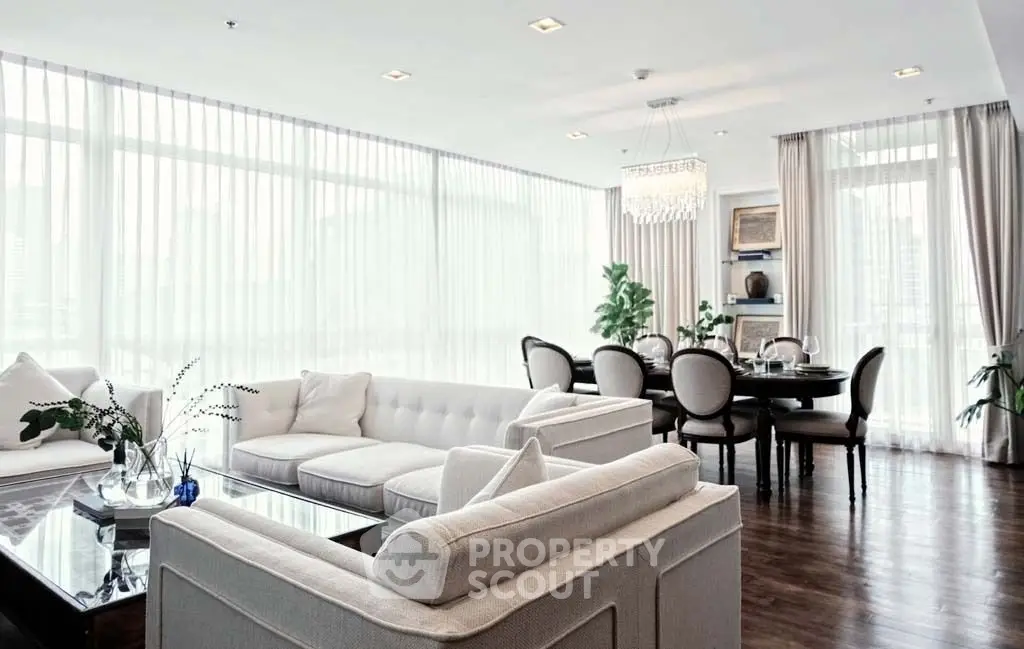 Luxurious living room with elegant dining area and large windows