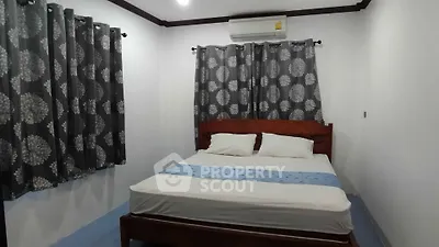 Cozy bedroom with air conditioning and stylish curtains, perfect for restful nights.
