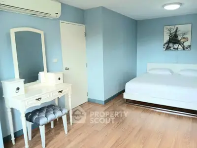 Spacious bedroom with elegant vanity and modern decor