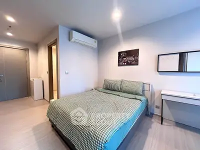 Modern bedroom with stylish decor and air conditioning in a contemporary apartment.