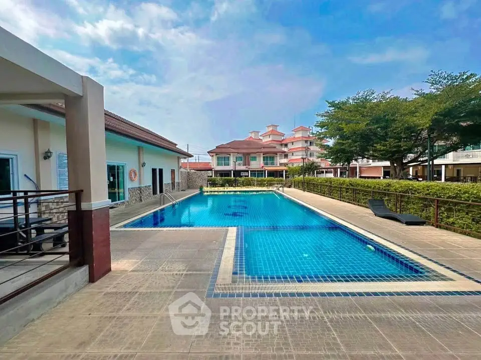 Luxurious residential pool area with modern architecture and serene surroundings.