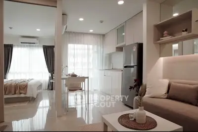 Modern open-plan apartment with cozy living area and sleek kitchen