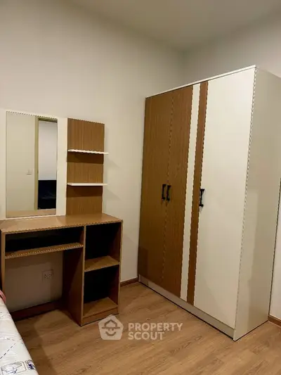 Modern bedroom with sleek wardrobe and stylish vanity desk, perfect for urban living.
