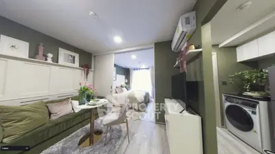 Stylish modern apartment with open living area, cozy bedroom, and compact kitchen featuring washer and dryer.