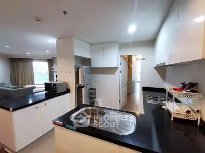 Modern open kitchen with sleek countertops and spacious living area