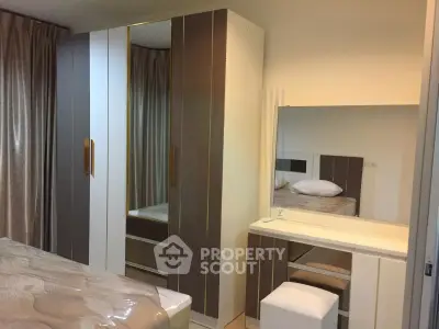Cozy bedroom with modern wardrobe and dressing table, perfect for stylish living.