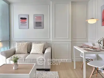 Modern living room with elegant decor and dining area, featuring stylish furniture and wall art.