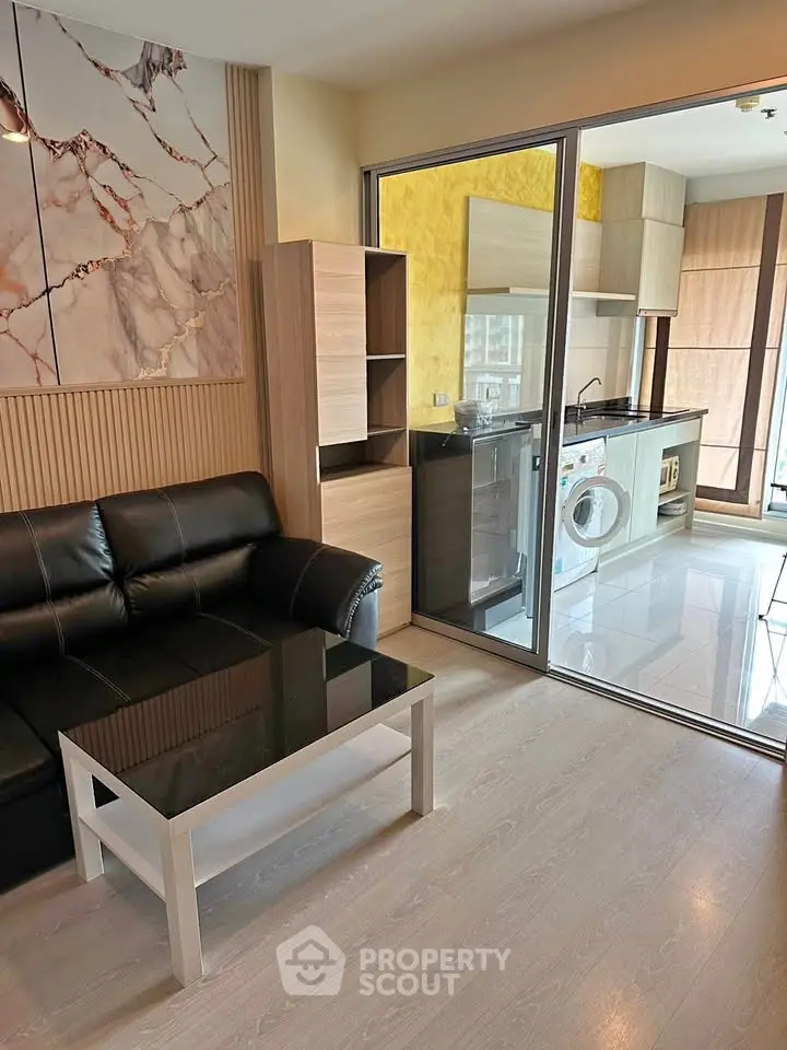 Modern living room with open kitchen and stylish decor in a contemporary apartment.