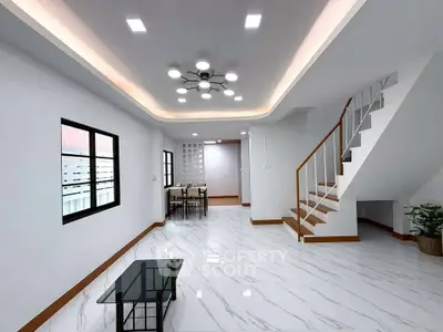 Modern living room with elegant staircase and stylish lighting