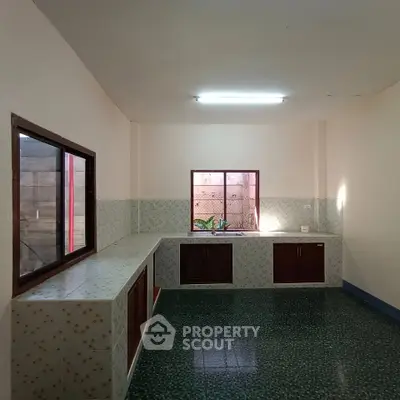 Spacious kitchen with ample counter space and natural light