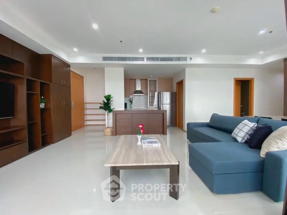 Spacious modern living room with open kitchen and stylish furniture