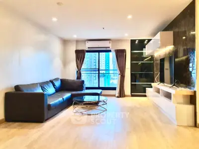 Spacious modern living room with sleek furniture and city view, perfect for urban living.