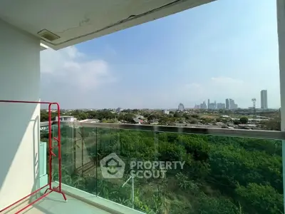 Stunning balcony view with city skyline and lush greenery, perfect for relaxation and enjoying urban living.