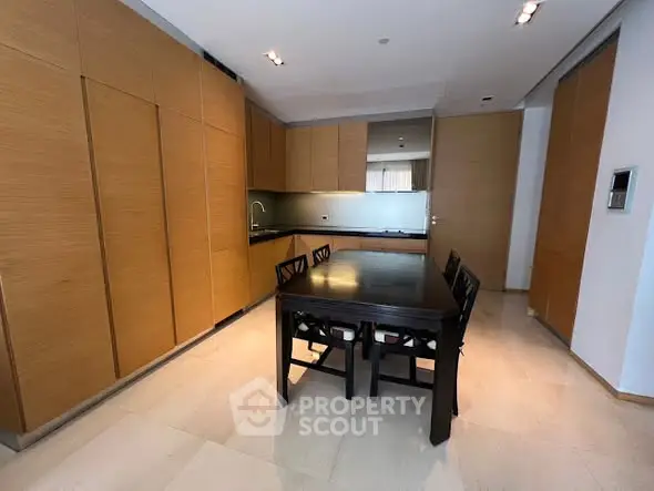 Modern kitchen with sleek wooden cabinets and dining table