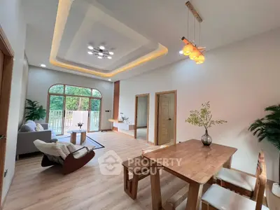 Spacious modern living room with elegant wooden furniture and large windows.