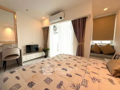 Cozy bedroom with modern decor and natural light, featuring a comfortable bed and stylish furnishings.