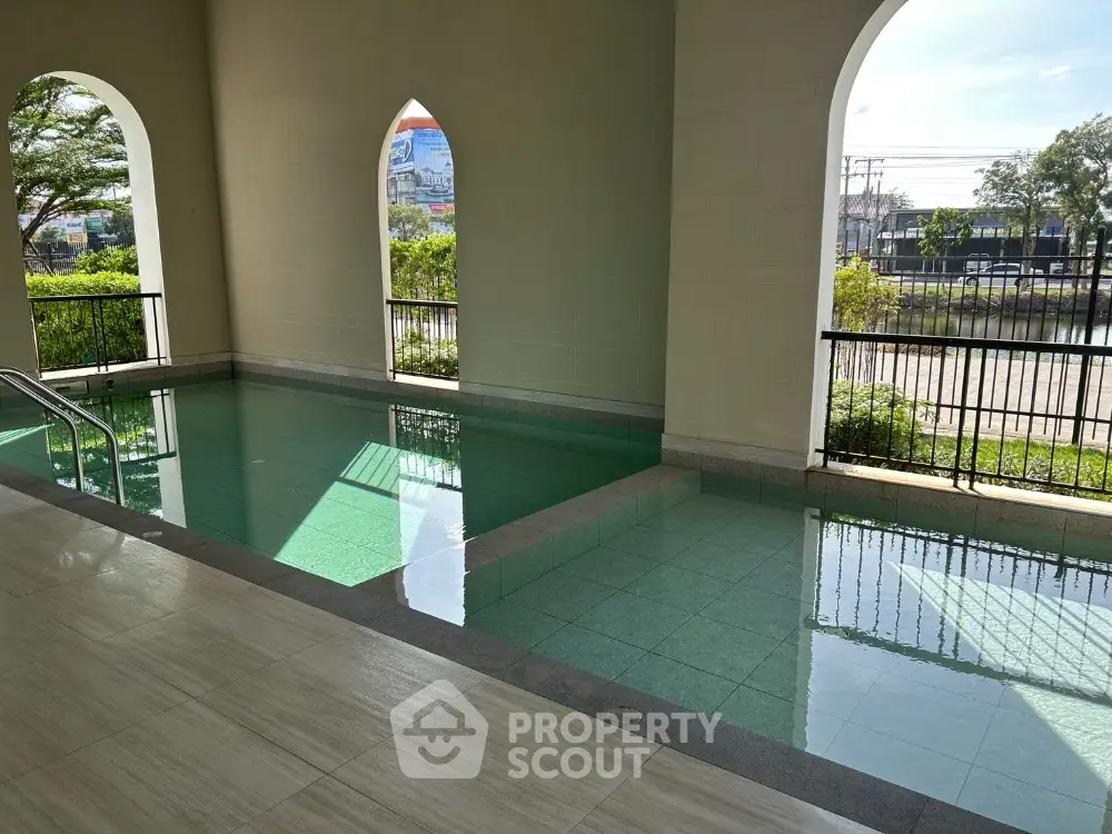 Luxurious indoor pool area with elegant arches and serene ambiance