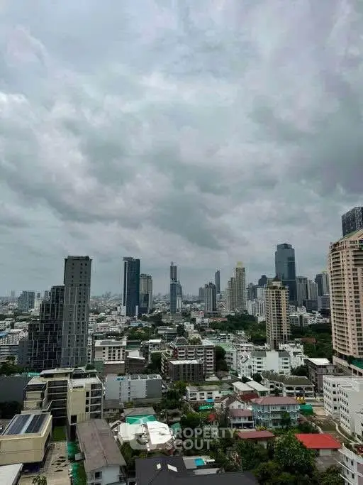 Stunning cityscape view showcasing modern skyscrapers and urban skyline under a dramatic cloudy sky.