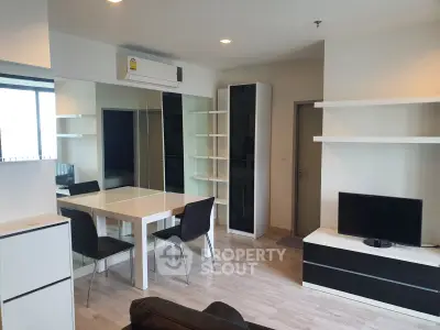 Modern living room with sleek furniture and built-in shelves in a stylish apartment.