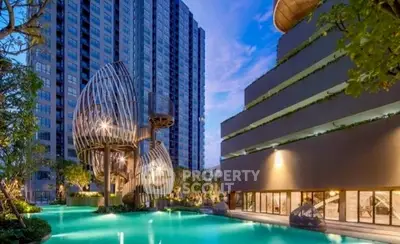 Luxurious modern apartment complex with stunning pool and unique architectural design.