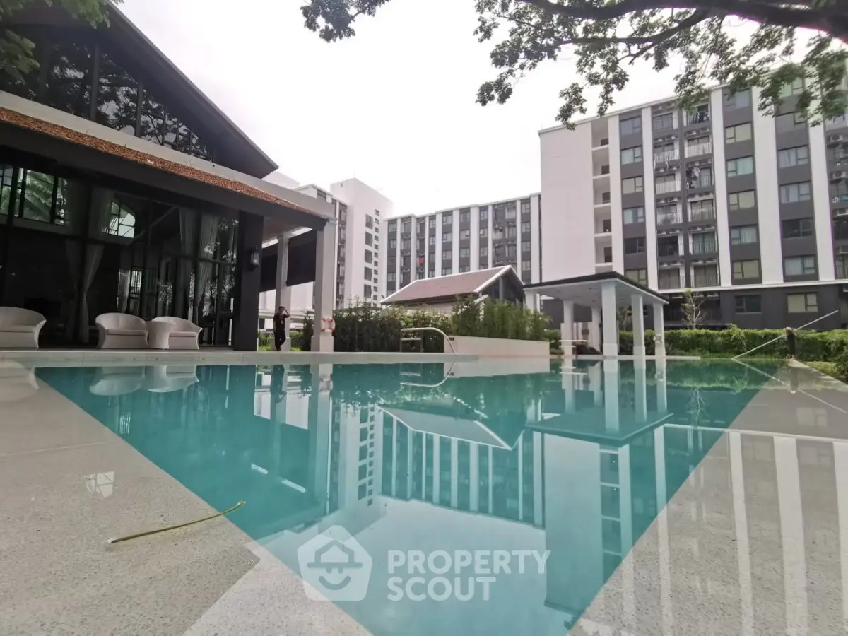 Luxurious apartment complex with modern pool and lush greenery, perfect for relaxation and leisure.