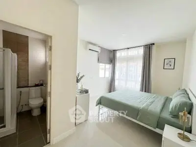 Spacious bedroom with ensuite bathroom and modern decor