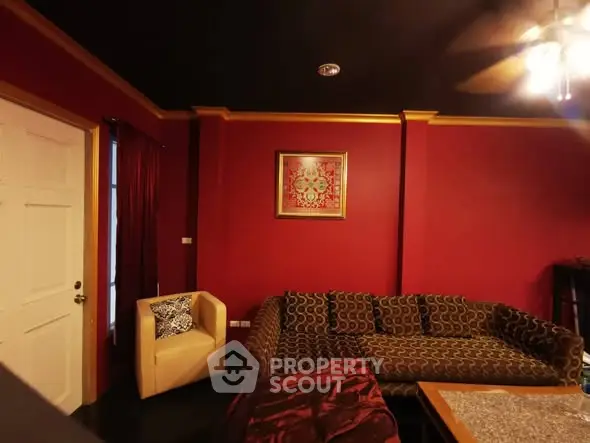 Luxurious living room with bold red walls and elegant furniture