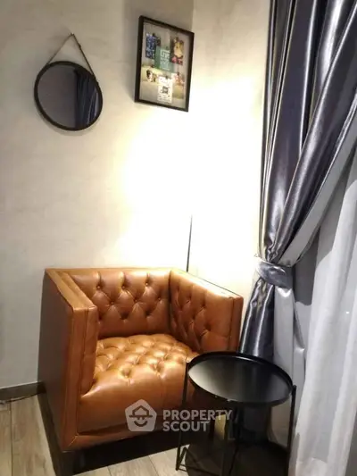 Cozy corner with a stylish leather armchair and elegant decor, perfect for relaxation.