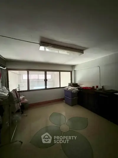 Cozy room with large window and unique floral carpet design