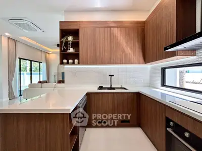 Modern kitchen with sleek wooden cabinetry and open layout in luxury home