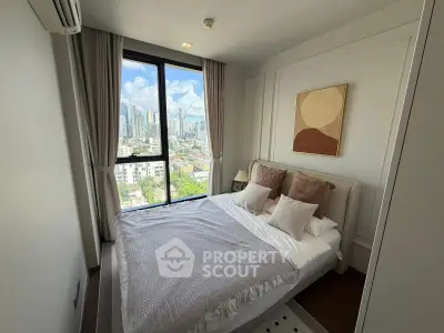 Chic bedroom with stunning city view and modern decor in high-rise apartment.