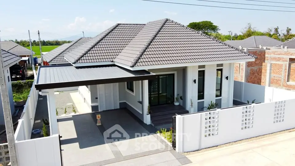 Modern single-story house with tiled roof and spacious driveway