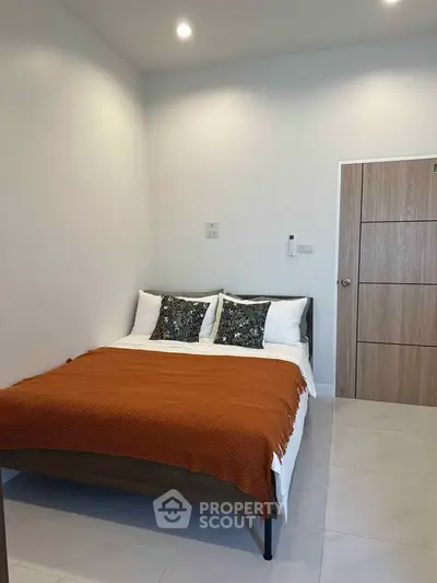 Cozy bedroom with modern decor and warm lighting