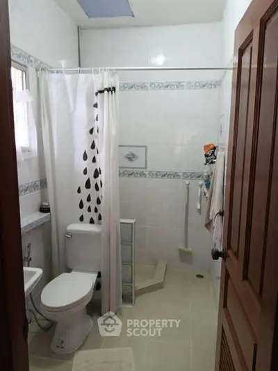 Spacious bathroom with modern shower and elegant tile design