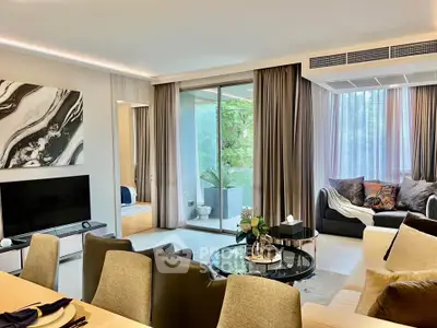 Luxurious living room with modern decor and large windows overlooking greenery.