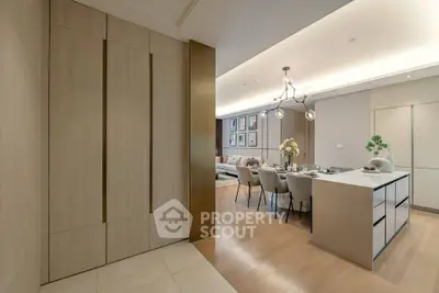 Modern open-plan living and dining area with elegant lighting and stylish decor