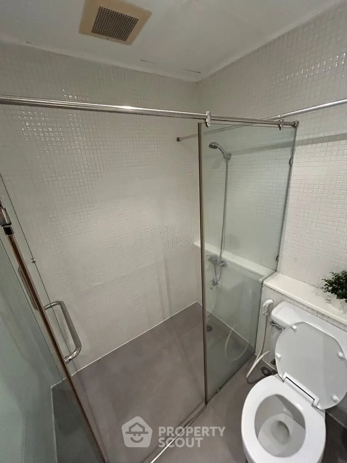 Modern bathroom with glass shower enclosure and sleek fixtures