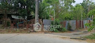 Charming rustic property with lush greenery and potential for renovation in a serene neighborhood.