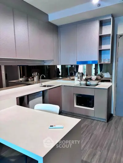 Modern kitchen with sleek cabinetry and integrated appliances in a stylish apartment.